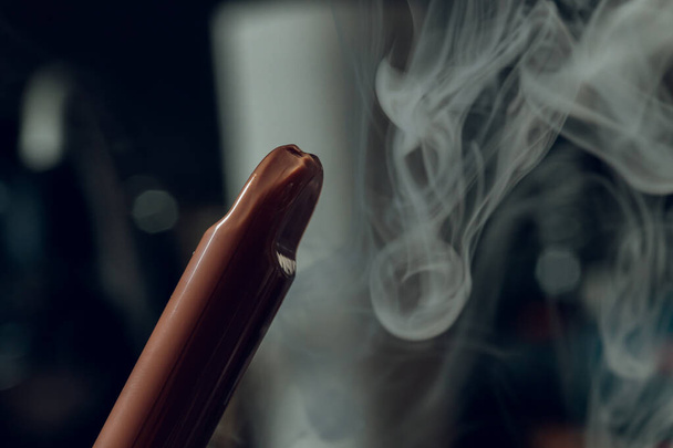 Man smokes new Vape Pod System, inhales and exhales vapor of electronic cigarette, vaping concept. - Foto, Imagen