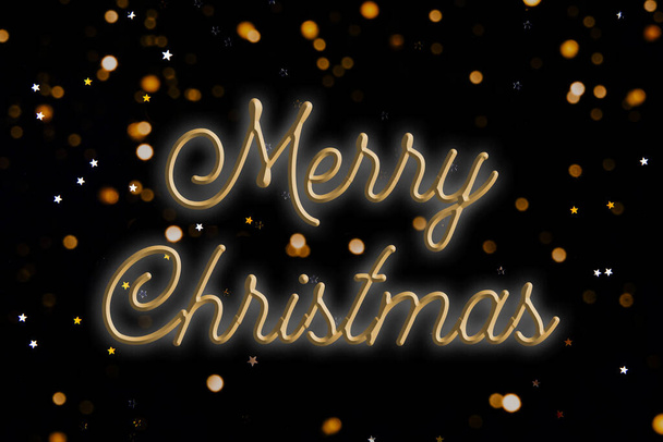 Woorden Merry CHRISTMAS op een zwarte achtergrond. - Foto, afbeelding