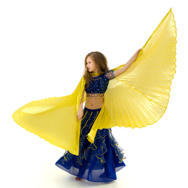 Blonde Girl in Oriental Costume Dancing Belly Dance with Wings - Fotó, kép
