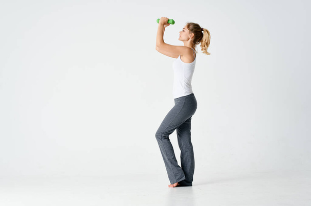 woman doing exercises in sportswear on a light background indoors - Foto, immagini