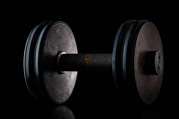 Old dumbbell on a black background - Photo, Image