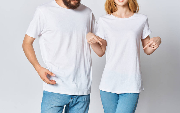 man and woman in white t-shirts and jeans fashionable style clothes - Fotó, kép
