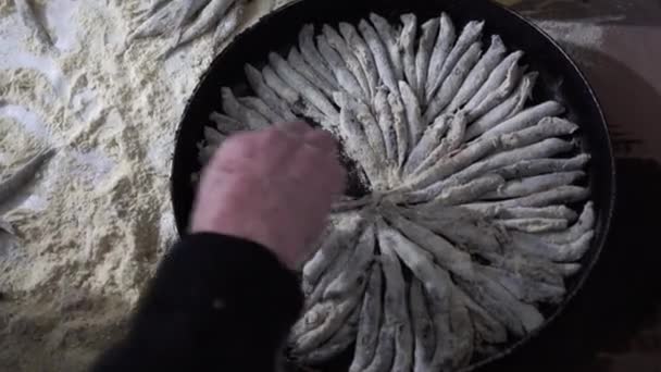 A chefs placing capelin fish on the iron pan. - Footage, Video