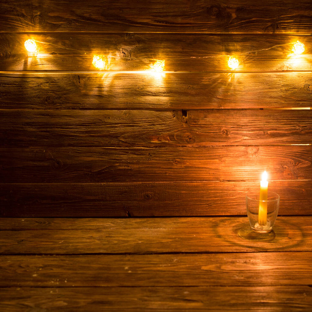 Candle on old plank. Christmas wooden background. - Fotoğraf, Görsel