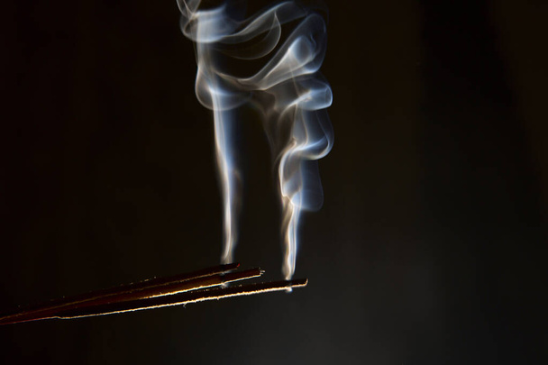 white rising smoke from aromatic stick on dark background - Photo, Image
