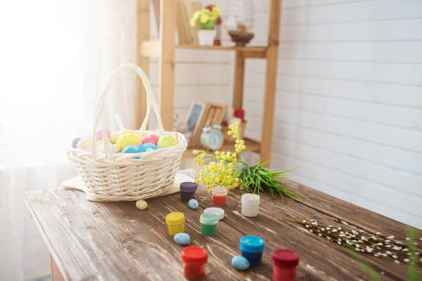 Colorful easter eggs and brushes on a wooden table - Фото, зображення