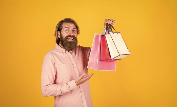 Incredible time while shopping. commonly used for birthday. buy anniversary gifts. surprised male open shopping bag with something exciting inside. mature man looking casual in surprise with package - Photo, Image