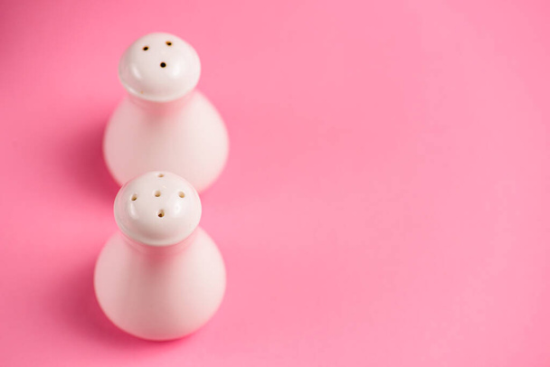 Salt and Pepper shaker isolated on pastel pink background. Copy space banner. - Zdjęcie, obraz