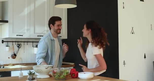 Overjoyed loving millennial caucasian couple dancing in kitchen. - Filmati, video