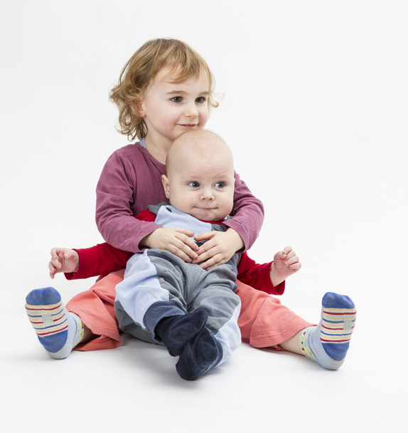 siblings isolated in light background - Photo, image