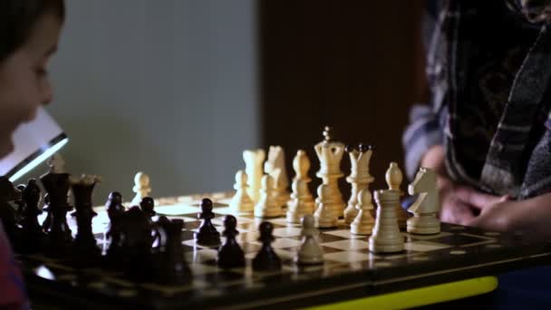 Grandmother playing chess with her grandson at home. close up view. Slow motion footage. Shot video. - Footage, Video