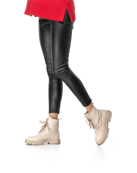 Slender female legs in black leggings and boots isolated on white background - Photo, Image