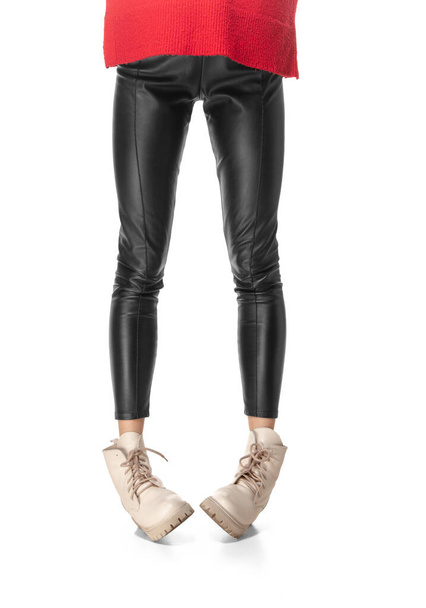 Slim long female legs in black leggings and boots isolated on white background - Photo, Image