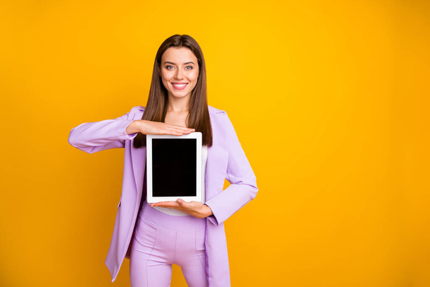 Photo of amazing business lady holding e-reader offer good discount price advising buyers new model of tablet wear lilac suit isolated yellow color background - Foto, imagen