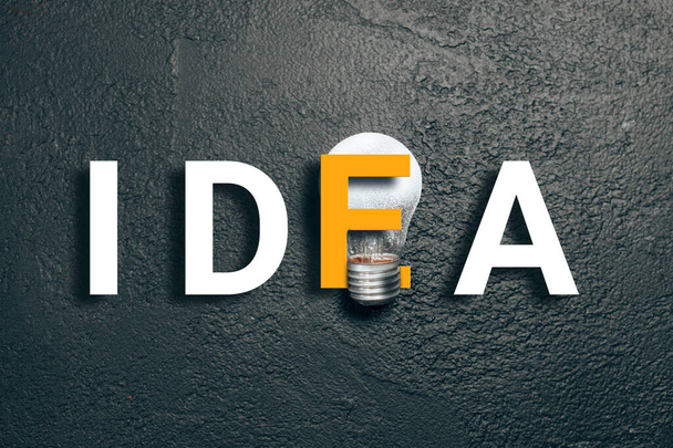 2021 idea minimal concept. White text with glass glowing light bulb on dark gradient background. Business solution - Photo, Image