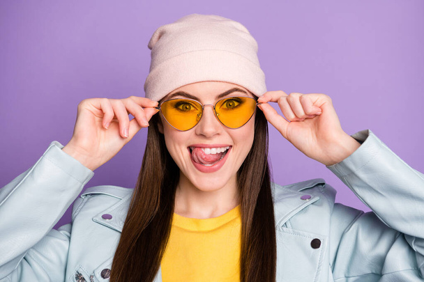 Portrait of positive cheerful youth girl imagine yummy sweet dessert lick tongue teeth touch modern specs wear casual style clothes isolated over purple color background - Foto, Imagem