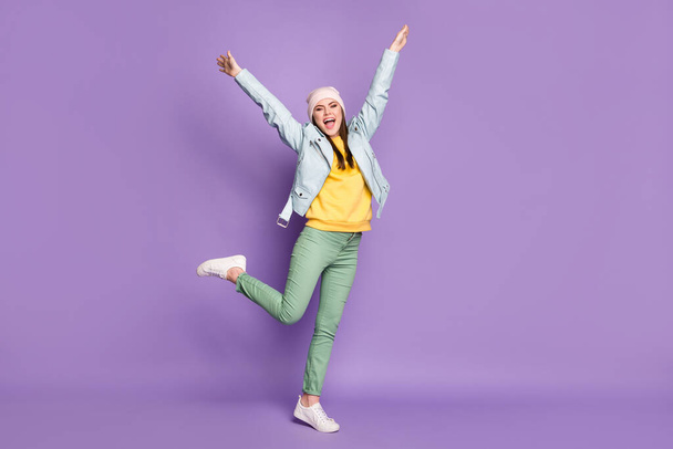 Full size photo of crazy attractive lady spring weather nice day street clothes good mood walk raise arms up wear casual hat modern jacket pants shoes isolated purple color background - Foto, Imagem