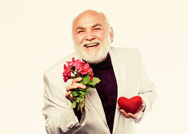 Health treatment. problems with heart. businessman. heart failure. happy mature man hold flowers and heart. anniversary and valentines day. donor transplant. love and romance. Best Valentines Day - Fotoğraf, Görsel