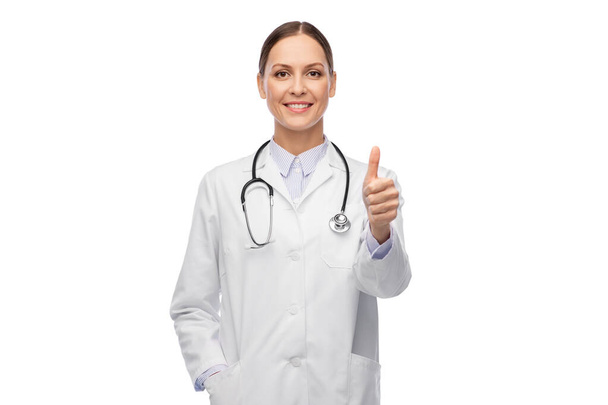 smiling female doctor showing thumbs up - Фото, изображение