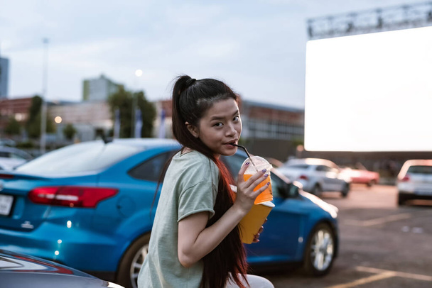 Young girl looking at camera at auto cinema during session - Φωτογραφία, εικόνα