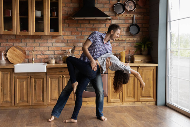 Young couple having date indoors dancing passionate disco at kitchen - Valokuva, kuva