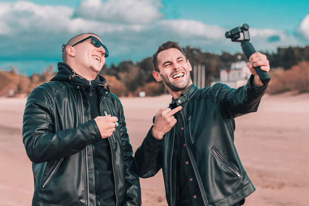 Two Handsome Guys Making Selfie Using Action Camera - Photo, image