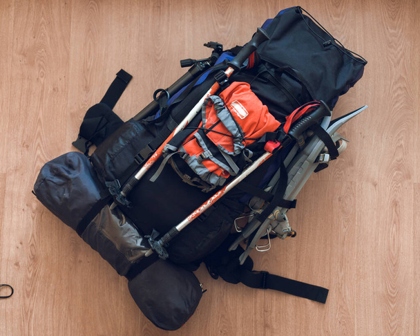Assembled tourist backpack for winter hiking in the mountains. Sticks, snowshoes, a tent, and a camera tripod. - Photo, image
