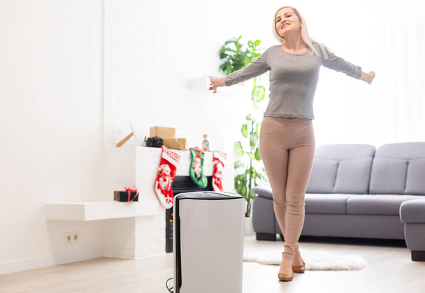 Coronavirus panic, Air purifier in a living room, Humidification air in apartment during period self-isolation due coronavirus pandemic - Photo, Image