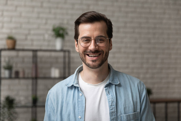 Happy young man posing for headshot portrait profile picture indoors - Foto, immagini
