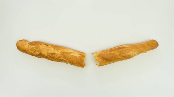 Fresh and crispy French baguettes on a white plate. - Photo, Image