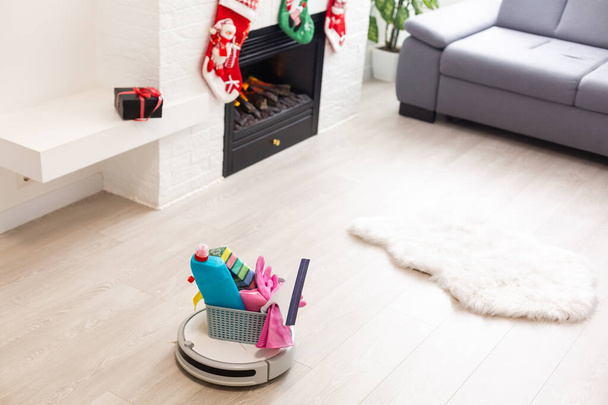 Robotic vacuum cleaner on laminate wood floor smart cleaning technology. Cristmas tree - Photo, Image