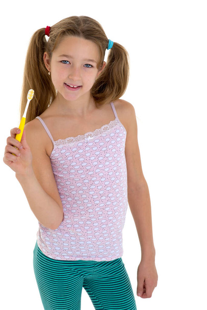 Smiling girl standing with toothbrush - Fotó, kép