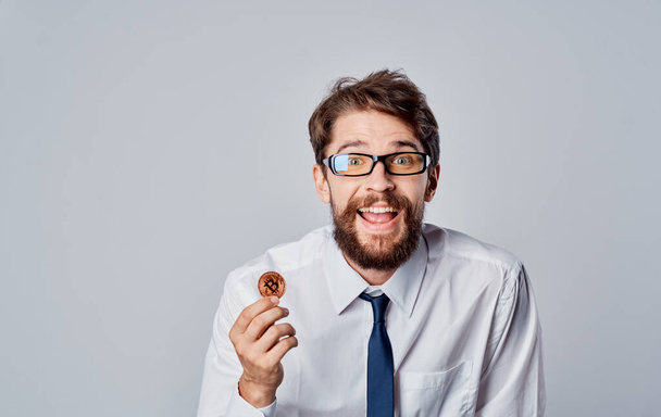 man with a coin in his hand success joy cryptocurrency Bitcoin gray background Copy Space - 写真・画像