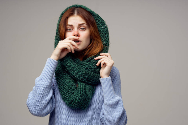 woman knitted scarf on her head health problems runny nose blue sweater - 写真・画像
