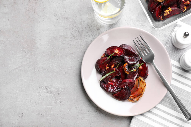 Roasted beetroot slices served on light grey table, flat lay. Space for text - Foto, Imagem
