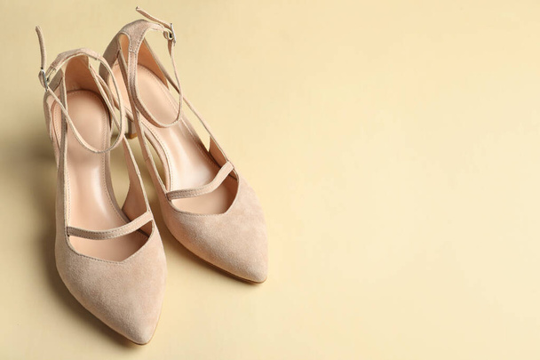 Stylish high heeled shoes on beige background, space for text - Valokuva, kuva