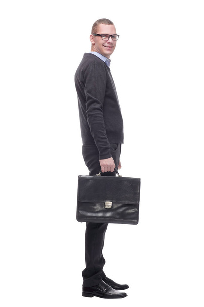 Side view of a business man holding a briefcase and looking away - Фото, изображение
