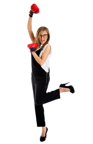 Winning business woman celebrating wearing boxing gloves and bus - Foto, immagini