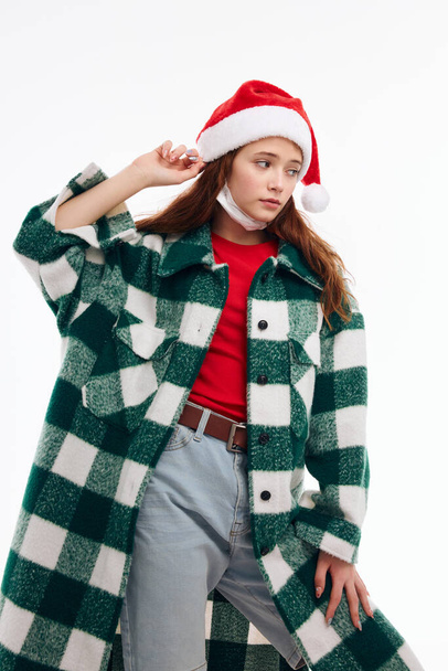 pretty woman wearing santa hat plaid coat new year clothes holiday - Foto, afbeelding