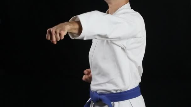  With a blue belt the athlete beats punches - Footage, Video