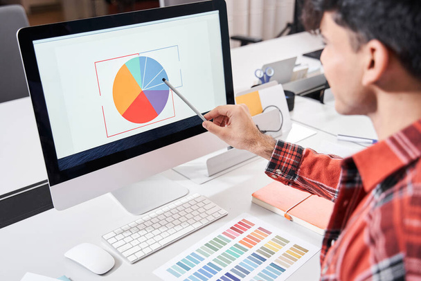Designer looking at colour chart - Foto, immagini