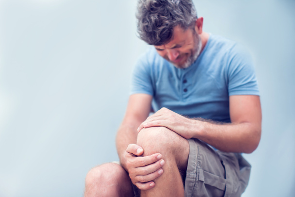 Man with knee pain close up. Pain relief concept - 写真・画像
