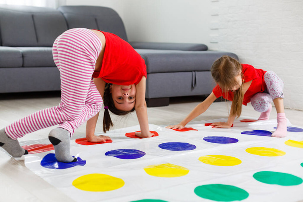 two little girls Having Fun Playing Game On Floor At Home. Siblings Friendship - Foto, Imagem