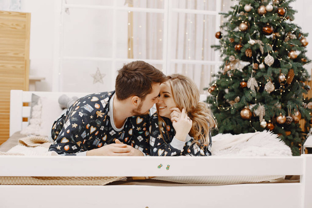 Cute couple at home near christmas tree - Valokuva, kuva