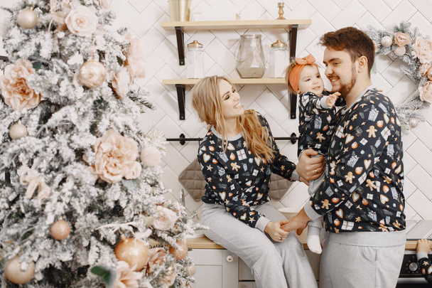 Family in identifical pajamas at home - 写真・画像