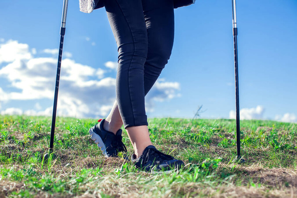 Nordic walking, exercise, sport, adventure, hiking concept -a woman hiking in the nature - 写真・画像