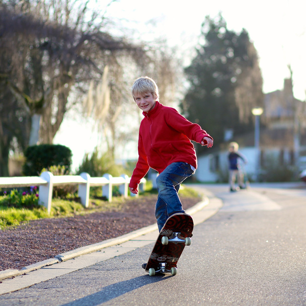 Boy learning to balance on skateboard - Фото, изображение