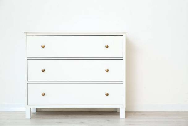 Modern chest of drawers near white wall - Foto, imagen