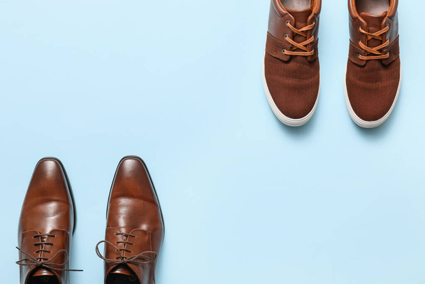 Different male shoes on color background - Фото, изображение