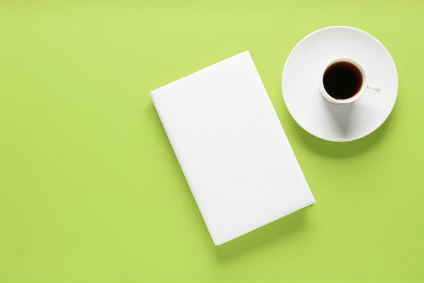 Blank book and cup of coffee on color background - Fotografie, Obrázek